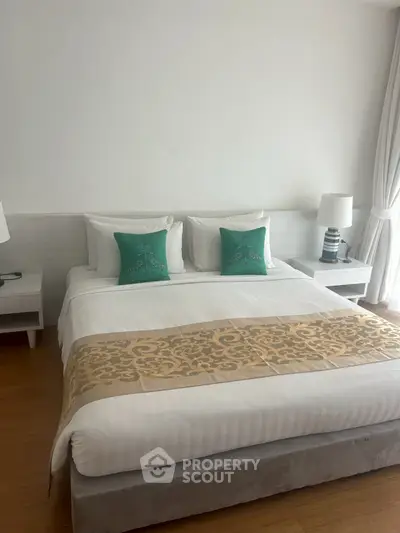 Elegant bedroom with stylish decor and natural light, featuring a cozy bed and modern furnishings.