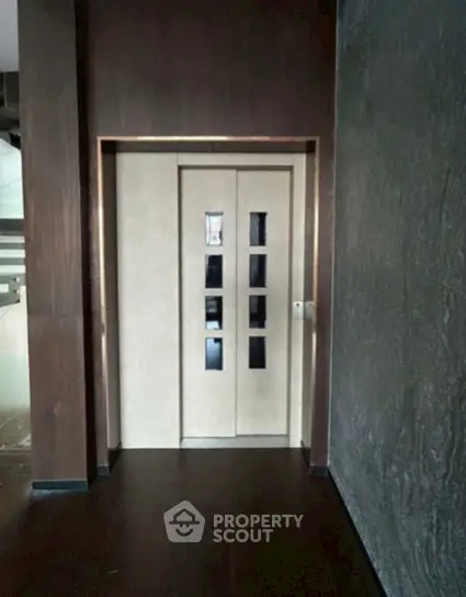 Modern building elevator with sleek wooden paneling and stylish design