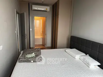 Modern bedroom with ensuite bathroom and air conditioning unit