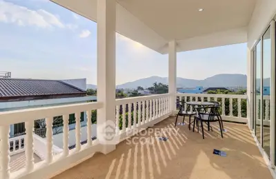Spacious balcony with stunning mountain views and outdoor seating, perfect for relaxation.