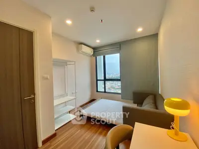 Modern minimalist living room with city view, featuring cozy sofa and stylish lighting.