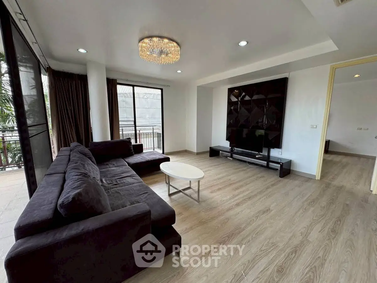 Spacious modern living room with elegant decor and large windows for natural light.