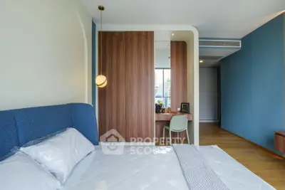 Modern bedroom with stylish wooden wardrobe and cozy blue accents, perfect for urban living.