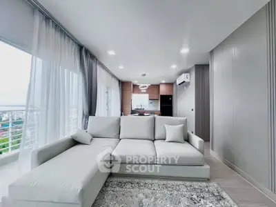 Spacious modern living room with large windows and elegant decor