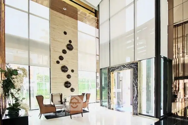 Luxurious modern building lobby with high ceilings and elegant seating area.