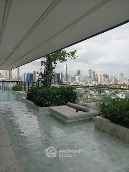 Luxurious rooftop with stunning city skyline view and elegant water feature.
