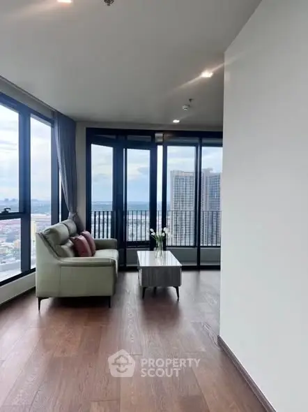 Spacious corner unit living room with panoramic city views and elegant decor.