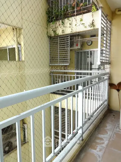 Secure balcony with safety netting in urban apartment building
