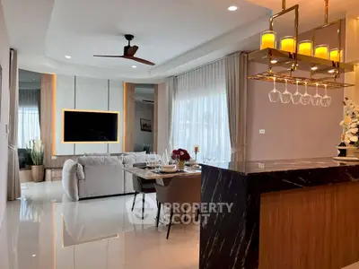 Luxurious open-plan living room with modern decor and elegant lighting