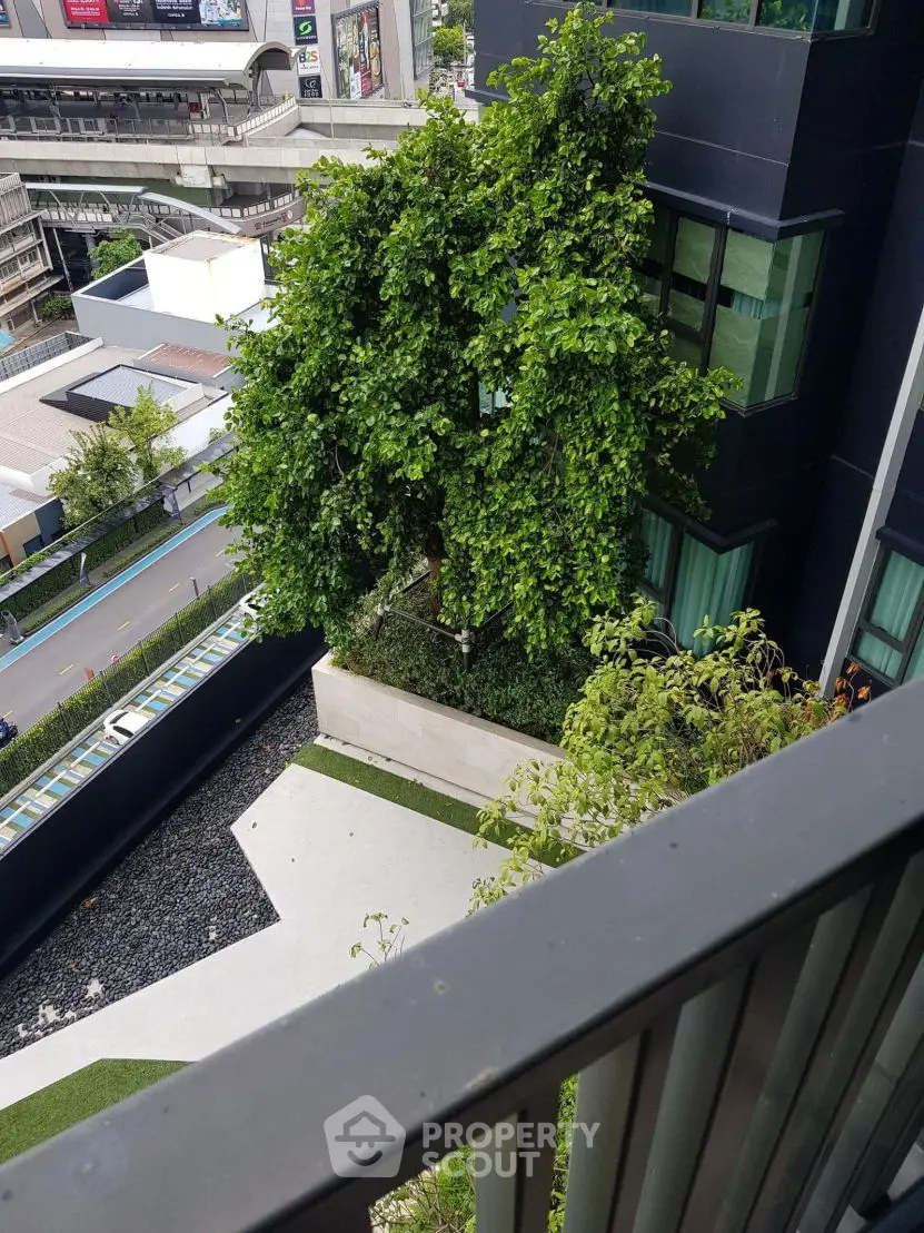 Modern urban building with lush greenery and city view from balcony
