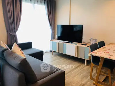 Modern living room with stylish furniture and large TV, perfect for relaxation and entertainment.