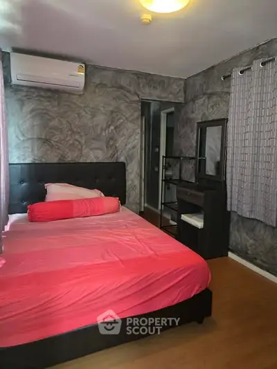 Cozy bedroom with modern decor and air conditioning, featuring a stylish bed and elegant curtains.