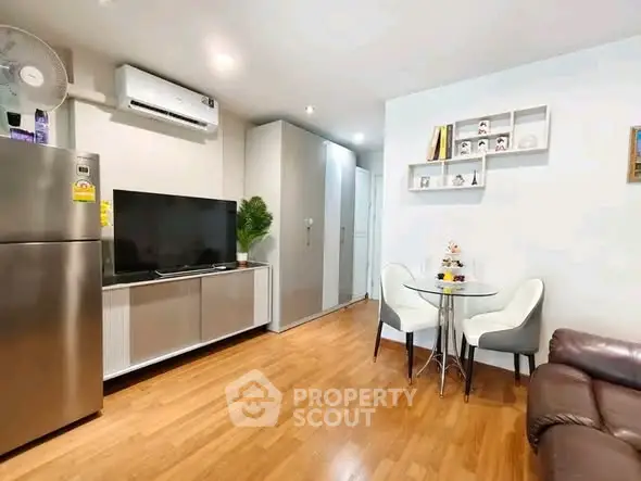 Modern living room with sleek furniture and wooden flooring in a cozy apartment.