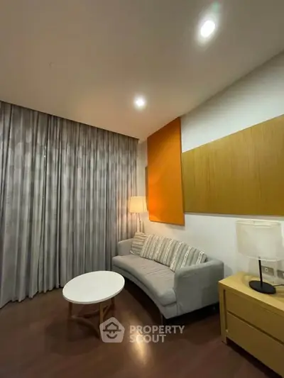 Cozy living room with modern sofa and stylish decor, perfect for relaxation.