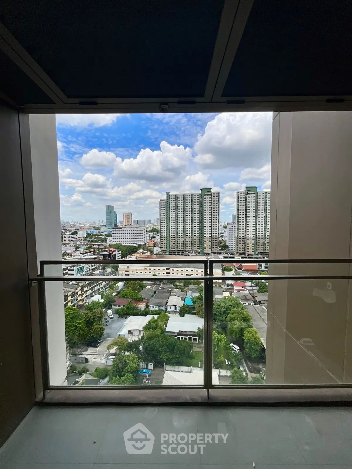 Stunning city view from high-rise balcony with clear blue sky