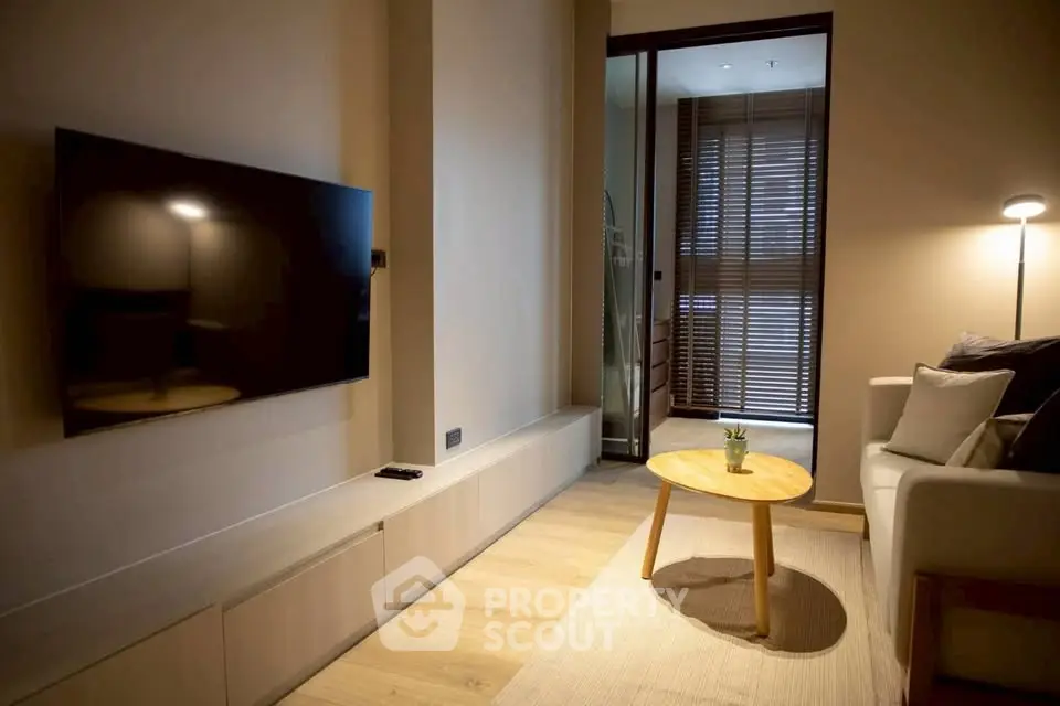 Modern living room with sleek TV and cozy seating area