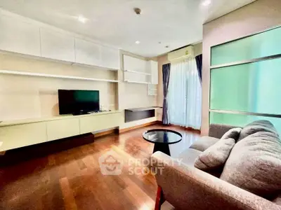 Spacious modern living room with hardwood floors and natural light