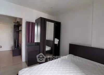 Modern bedroom with sleek furniture and ample storage space