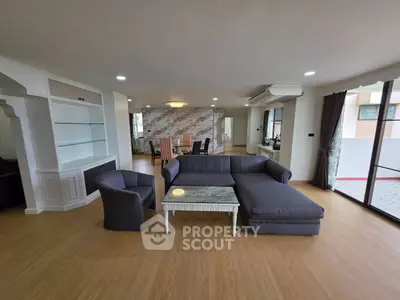 Spacious living room with modern furniture and large windows offering ample natural light.