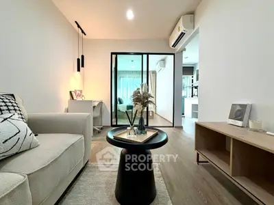 Modern living room with stylish decor and open layout, featuring cozy seating and elegant lighting.