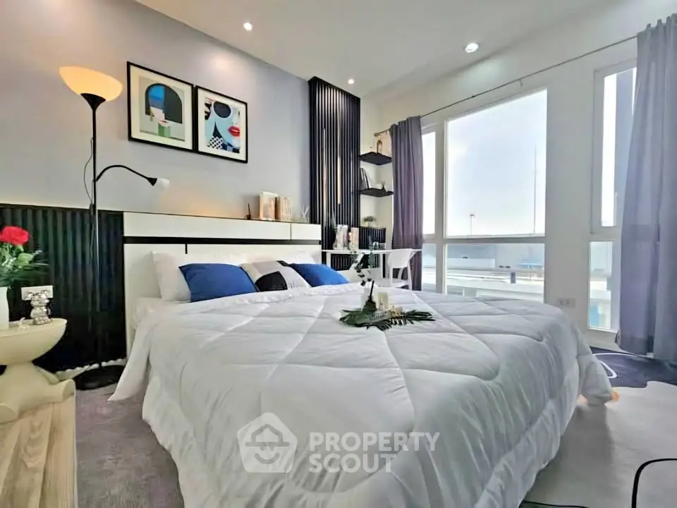 Luxurious bedroom with modern decor and large windows offering stunning views.