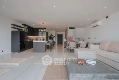Spacious open-plan living room with modern kitchen and stylish decor
