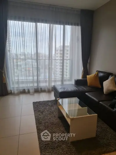 Modern living room with large window and stylish furniture