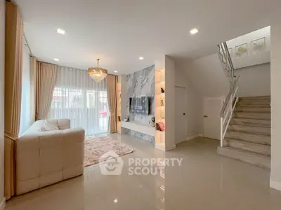 Spacious modern living room with elegant staircase and natural light