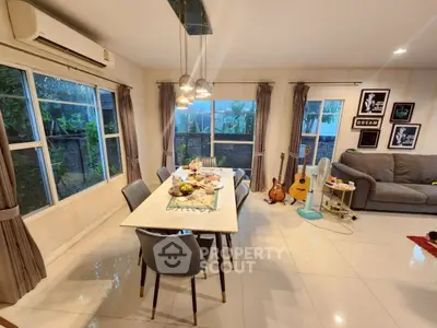 Spacious living room with modern dining area and cozy decor
