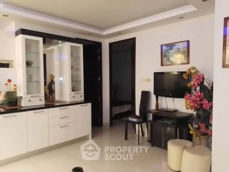 Modern living room with sleek white cabinetry and cozy decor