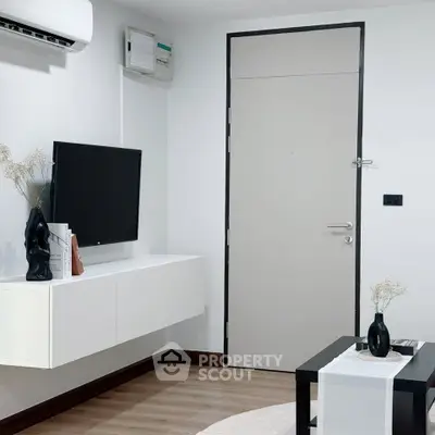 Modern living room with sleek decor and wall-mounted TV