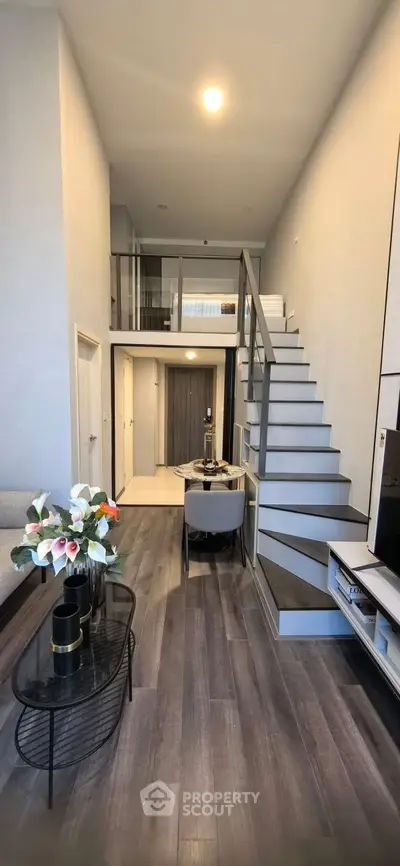 Modern duplex living room with high ceiling and stylish staircase