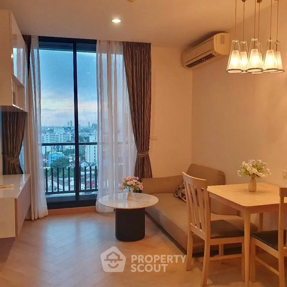 Charming living room with city view, cozy seating, and elegant lighting in modern apartment.