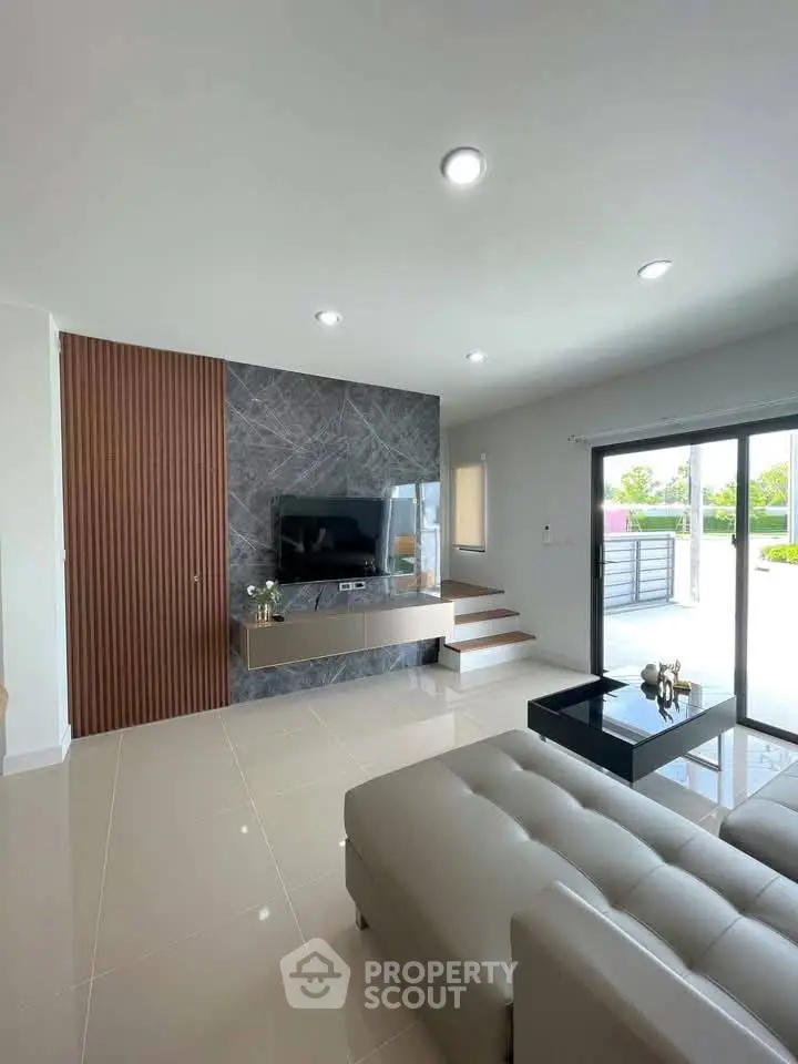 Modern living room with sleek design, large windows, and stylish furniture.