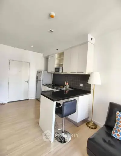 Modern kitchen with sleek black countertops and open layout in a stylish apartment.