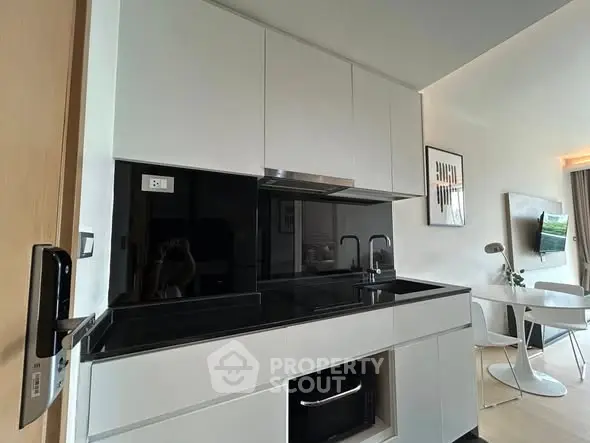 Modern kitchen with sleek black countertops and integrated appliances