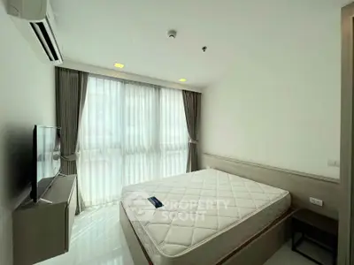 Bright bedroom with large window and modern furnishings