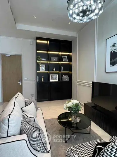 Elegant living room with modern decor, stylish shelving, and cozy seating area.