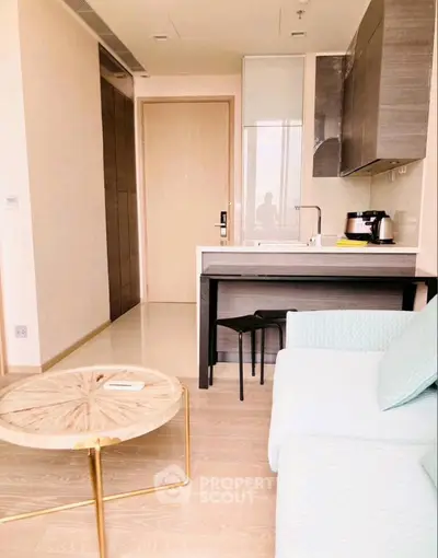 Modern apartment interior with cozy living area and compact kitchen, featuring stylish furniture and sleek design.