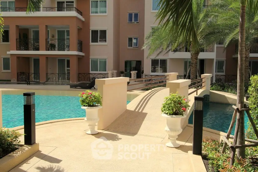 Luxurious apartment complex with inviting pool and lush greenery, perfect for relaxation and leisure.