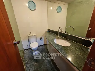 Elegant bathroom with marble countertop and modern fixtures in a stylish home.
