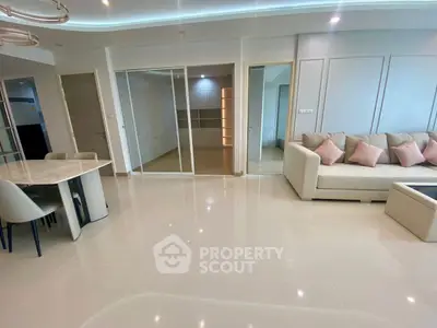 Spacious modern living room with elegant decor and ample natural light.
