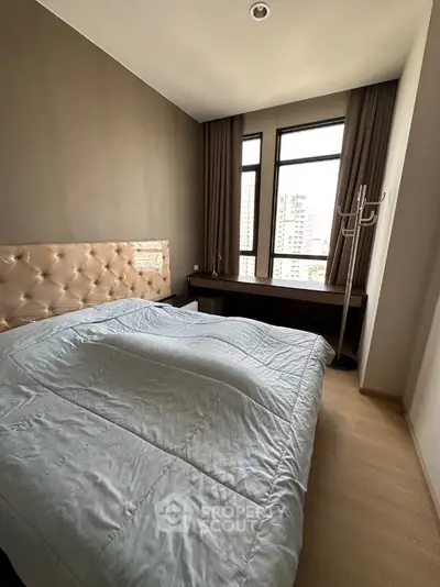 Modern bedroom with large windows and stylish decor in urban apartment