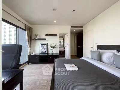 Spacious modern bedroom with balcony view in luxury apartment