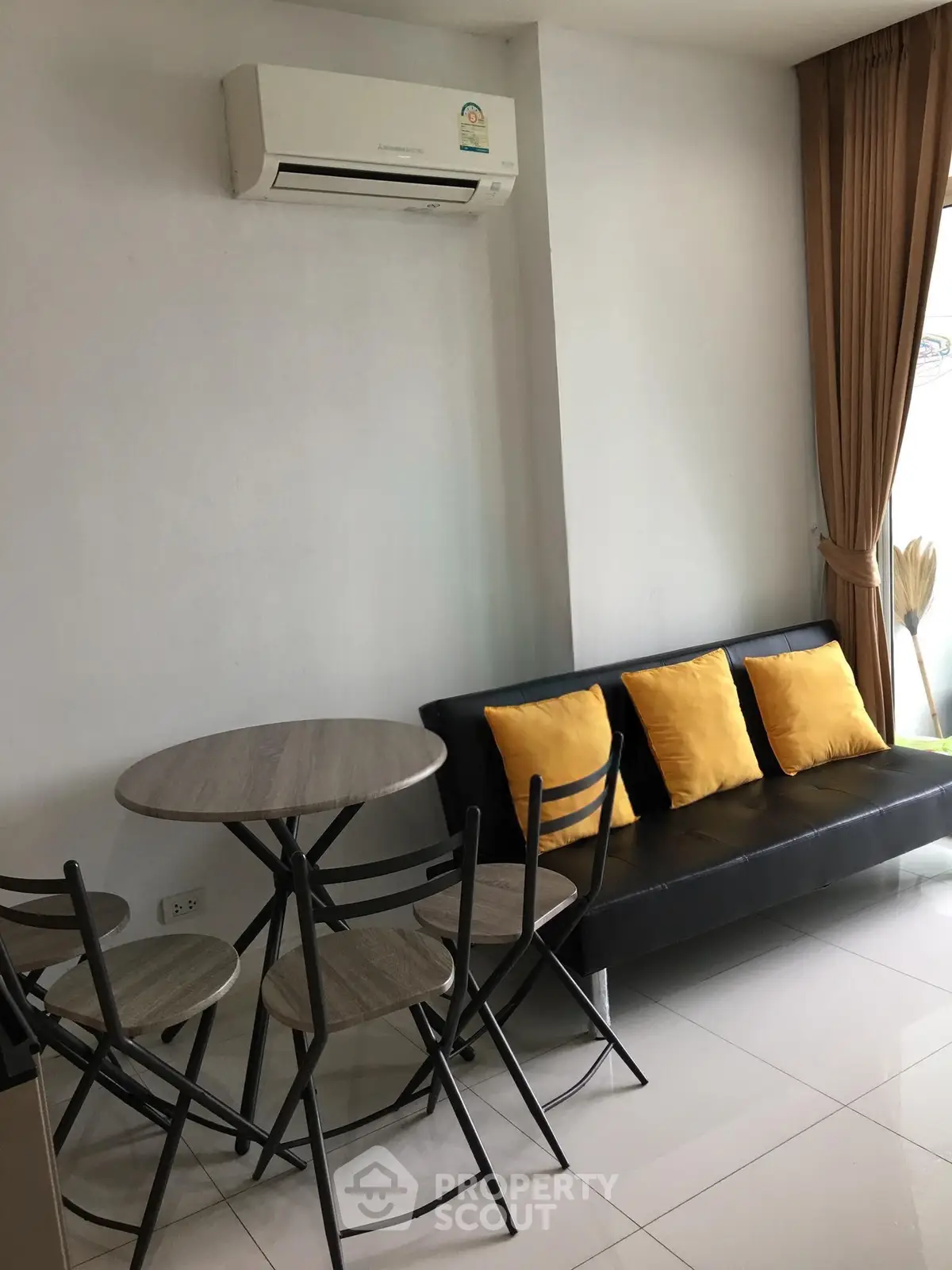 Modern living room with sleek furniture and air conditioning, perfect for cozy gatherings.