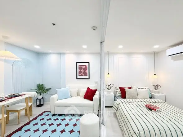 Modern open-plan living room and bedroom with stylish decor and cozy ambiance.