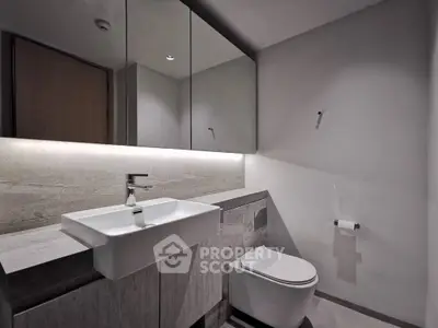Modern minimalist bathroom with sleek fixtures and ambient lighting