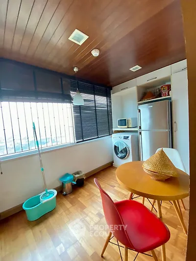 Charming kitchen with wooden ceiling, modern appliances, and city view.