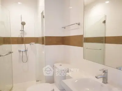 Modern bathroom with glass shower and sleek fixtures