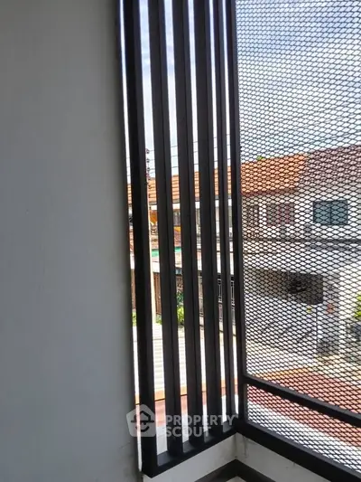 Modern balcony with sleek metal railing and urban view, perfect for city living.